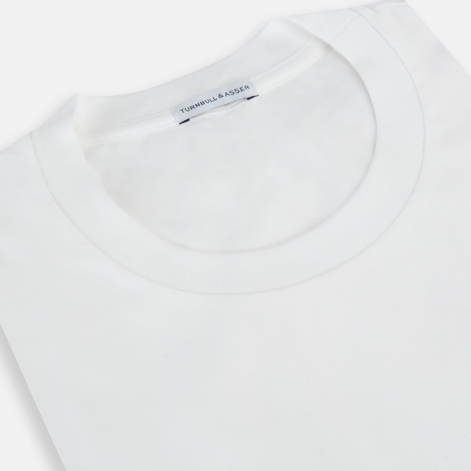 The Turnbull & Asser White Short-sleeve Pyjama Shirt is shown laid flat on a white background, featuring a plain, logo-free design for effortless comfort and classic loungewear style.