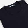A navy short-sleeve pyjama shirt by Turnbull & Asser is laid flat on a white background, featuring a round neckline and a minimalist design—perfect for relaxed wear.