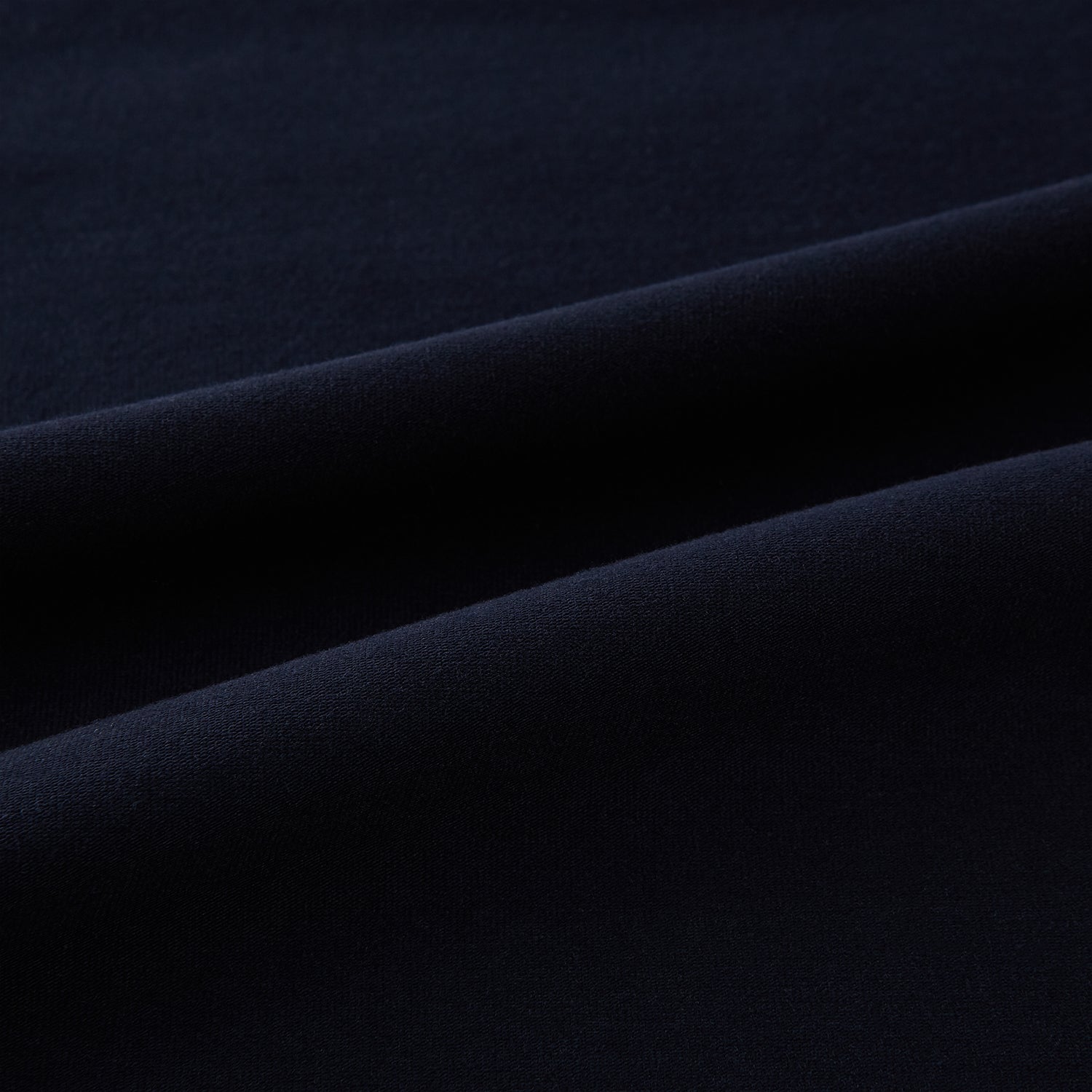 A navy short-sleeve pyjama shirt by Turnbull & Asser is laid flat on a white background, featuring a round neckline and a minimalist design—perfect for relaxed wear.