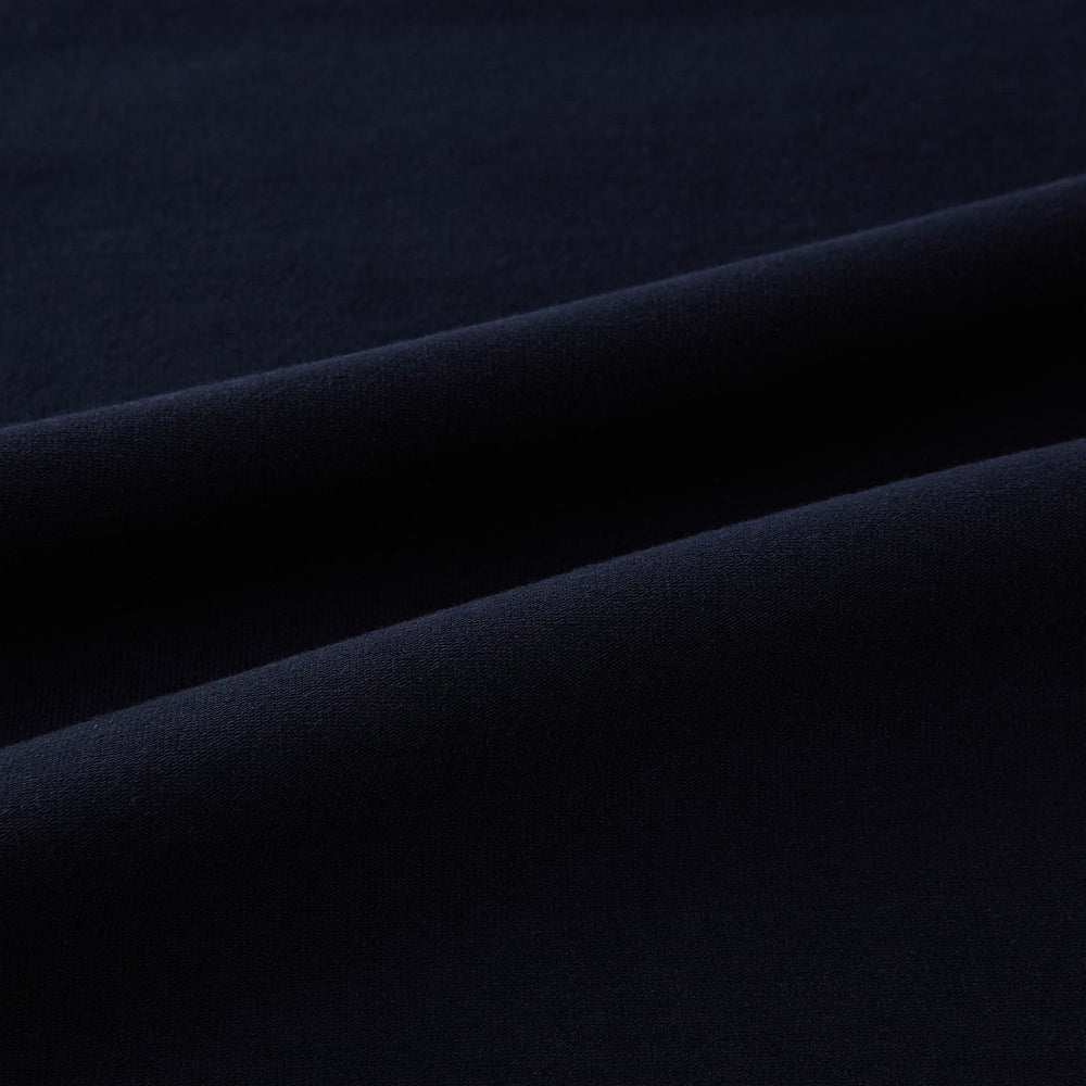 A navy short-sleeve pyjama shirt by Turnbull & Asser is laid flat on a white background, featuring a round neckline and a minimalist design—perfect for relaxed wear.