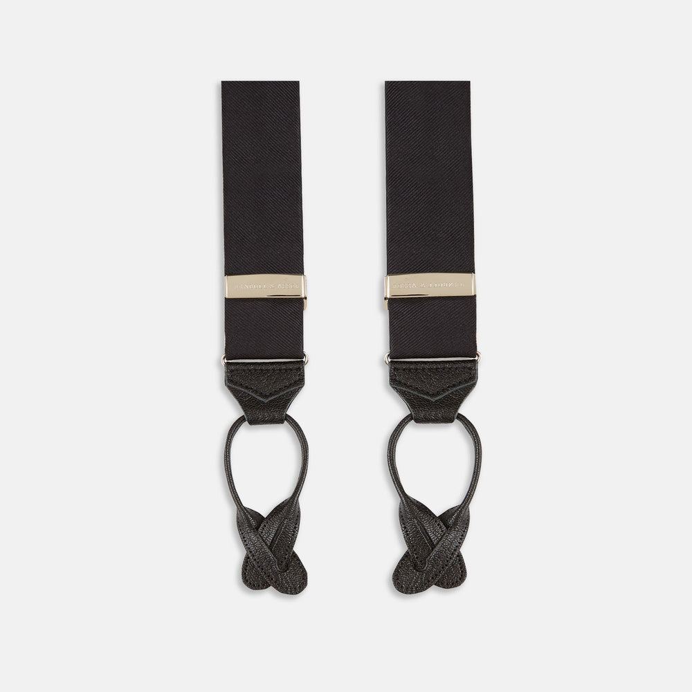 The Turnbull & Asser Black Herringbone Adjustable Silk Braces feature leather button loops and silver metal clips, shown on a white background—an elegant accessory to elevate any outfit.