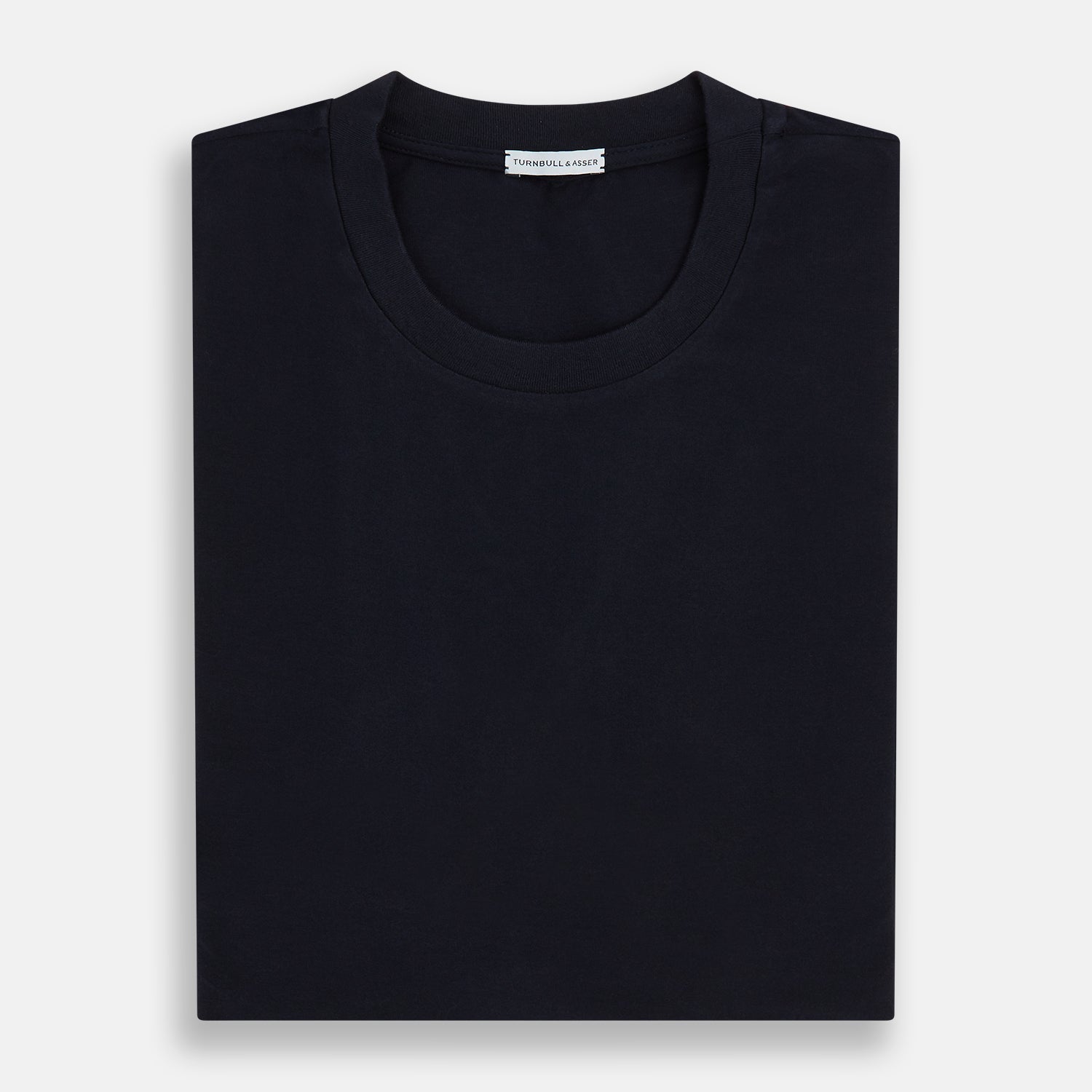 A navy short-sleeve pyjama shirt by Turnbull & Asser is laid flat on a white background, featuring a round neckline and a minimalist design—perfect for relaxed wear.