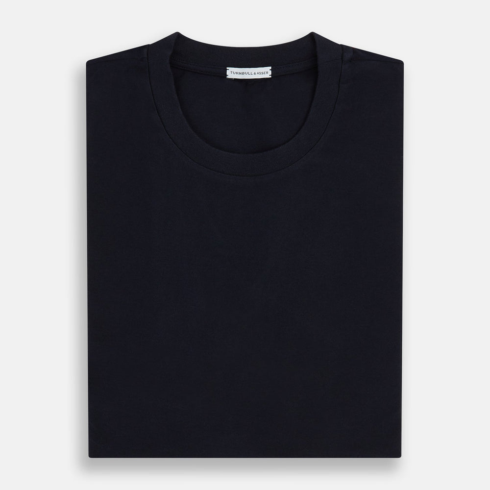 A navy short-sleeve pyjama shirt by Turnbull & Asser is laid flat on a white background, featuring a round neckline and a minimalist design—perfect for relaxed wear.